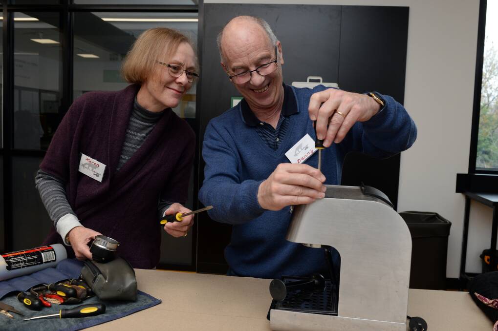 FIX IT: Karen and Danny Ellis work on repairing a coffee machine at the launch of the first Ballarat Repair Cafe event in July last year. Picture: Kate Healy