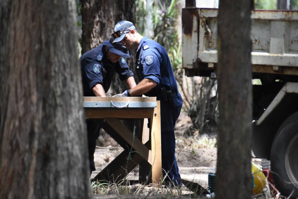 Combing for evidence: Officers sift through soil at the Cobb and Co Rd/Batar Creek Rd search site. Photo: Ruby Pascoe