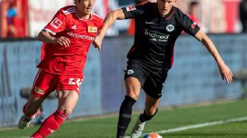 Socceroo Ajdin Hrustic (r) is hoping to help Eintracht beat Rangers in the Europa League final.