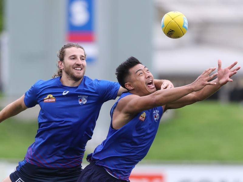Lin Jong (r) is working hard to be fit but is still uncertain when he will return to AFL action.