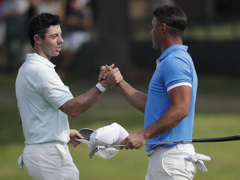 Rory McIlroy (L) has accused Brooks Koepka (R) of duplicity over his defection to LIV Golf.
