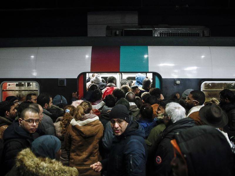 Commuters squeezed onto packed trains in Paris as strikes caused more havoc on transport networks.