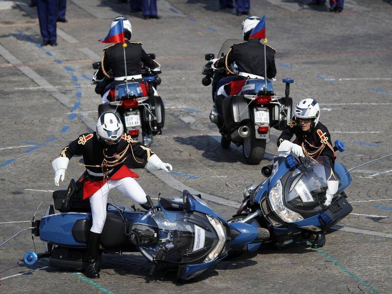 Two police motorbikes crashed during the Bastille Day parade on the Champs Elysees in Paris.