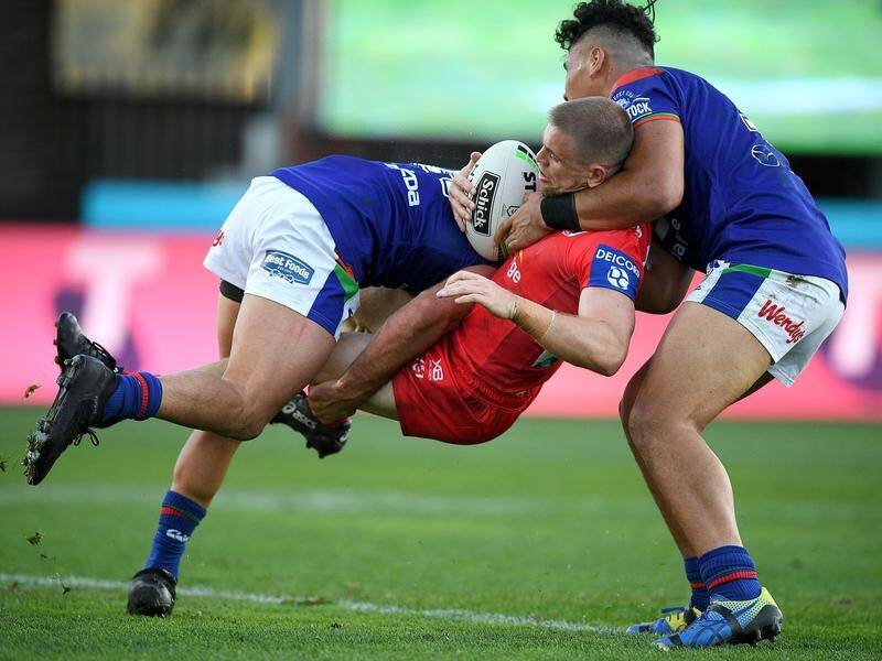 NZ's Karl Lawton (l) tackles the Dragons' Matthew Dufty in Saturday's almost flawless performance.