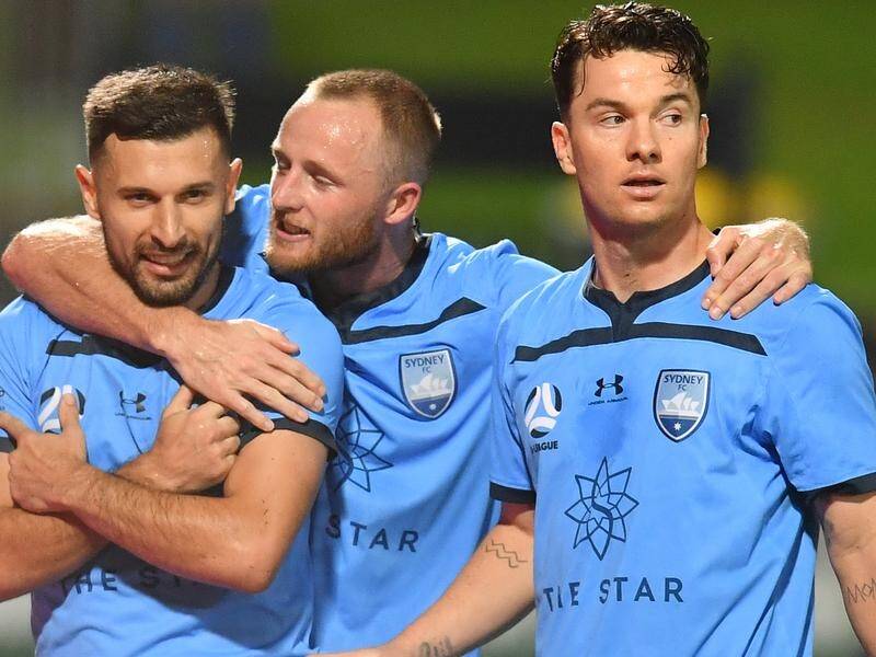 Kosta Barbarouses (l) celebrates his goal against Perth Glory with Rhyan Grant and Alex Baumjohann.