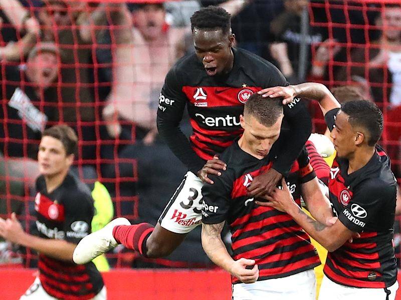 Teammates celebrate Mitch Duke's (c) goal for Western Sydney Wanderers against the Mariners.