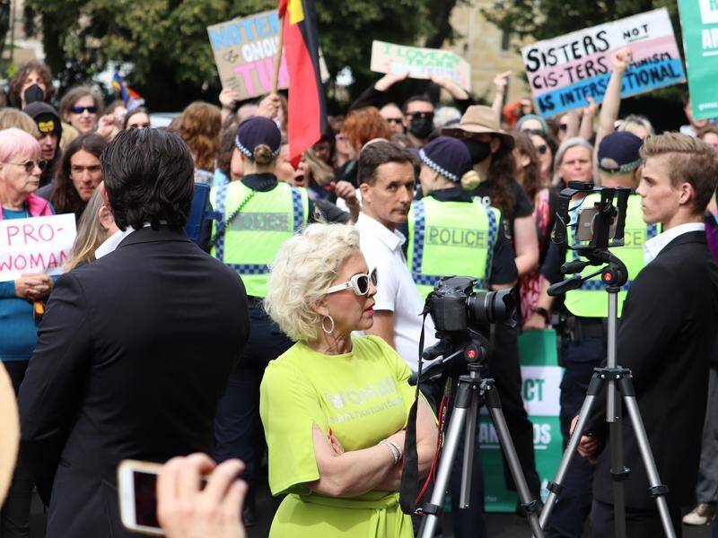 Anti-transgender activist Kellie-Jay Keen-Minshull (centre) was drowned out by protesters in Hobart. (Ethan James/AAP PHOTOS)