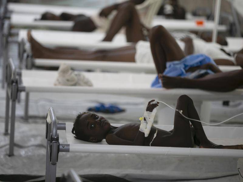 A child suffering cholera symptoms receives treatment at a Doctors Without Borders clinic in Haiti. (AP PHOTO)