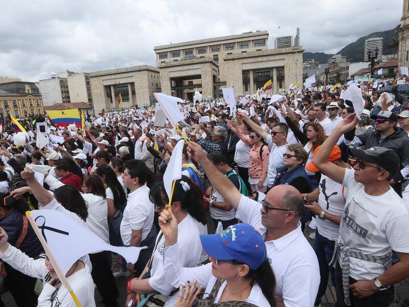 Colombians have marched against terrorism after a car bomb attack at a police academy in Bogota.
