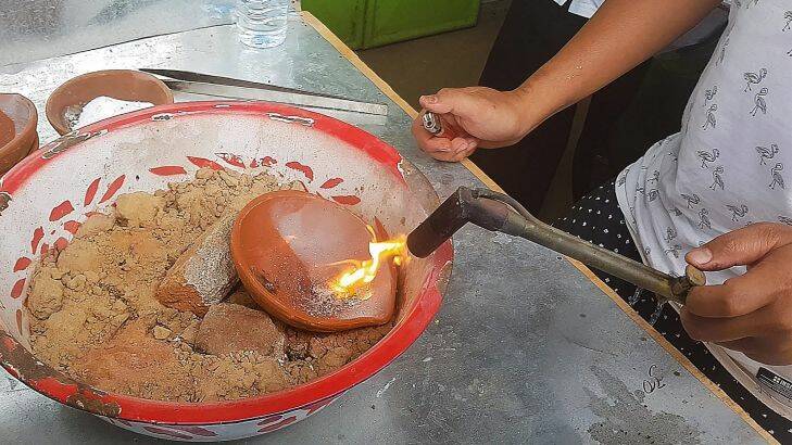 Edo uses a blow torch to purify the gold and release foreign particles such as mercury. Mercury is being used to extract gold from rock. A study has revealed that high levels of mercury have been found in women of child bearing age in Sekotong village, Lombok, Indonesia. 22nd September, 2017. Photo:Amilia Rosa                                 
