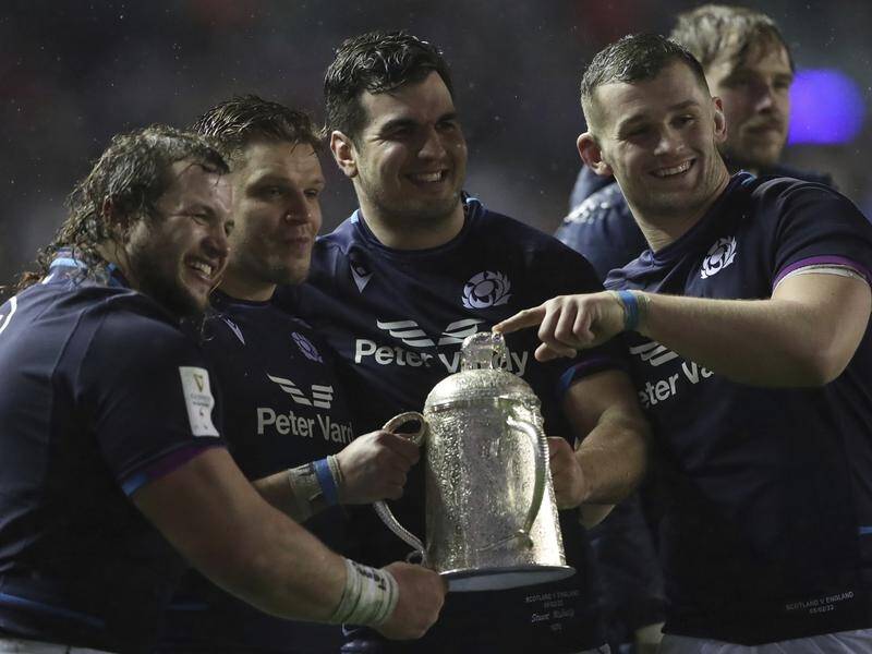 Scotland players pose with the Calcutta Cup after retaining the trophy in a thriller with England.