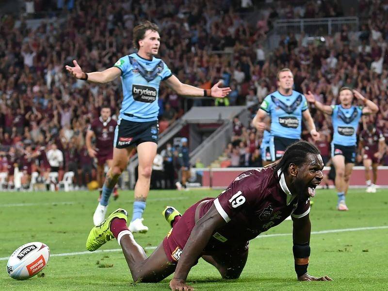 Edrick Lee scores a try for the victorious Maroons on debut while the Blues look on in despair.