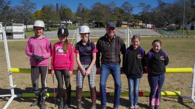 Renowned showjumping instructor Gavin Chester with competitors (from left) Carmen McGregor, Caitlin Reid, Ellie Grant, Jessica Clarke and Zoe Grant at the Bega Showjumping Club on the weekend..