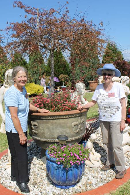 Horticultural Society of Canberra members Dawn Heinze (left) and Wendy Whitham admire Margaret Evans’s Kalaru garden during a tour of the district last Wednesday.