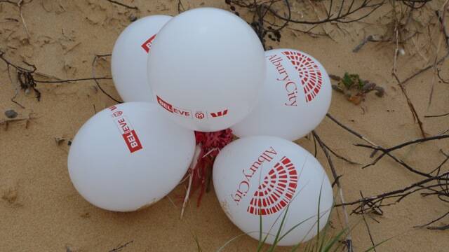A bunch of helium balloons found on a beach at Bermagui signal their Albury origins.
