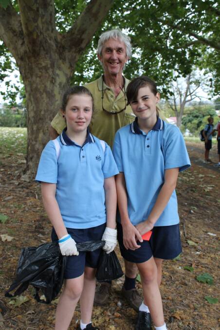 Eliana Hack, Chloe Cassandro and teacher Peter Whiting clean up at Bega Park.