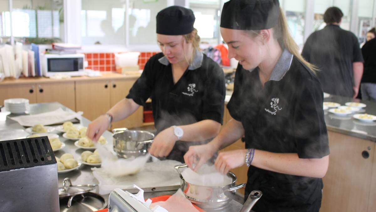 Krystal Grover and Paige Mott prepare delicious steamed chicken buns.