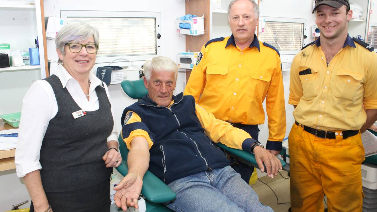 The Mobile Blood Service's Yetty Milford-Burgess preps Bega Valley Rural Fire Service volunteers (from left) Peter van Bracht, Lance Hartley and Jake Spears for their donation.