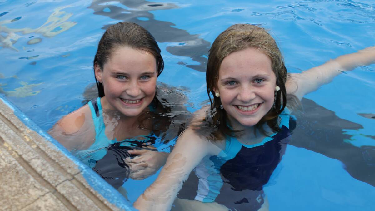 Enjoying the organised pool activities after the clean up are Year 7 students Nikki Ainsworth and Bree Monck.