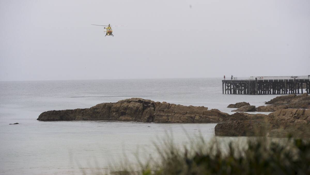 Emergency services continue the search for Christine Armstrong on Friday, who was taken by a shark while swimming at Tathra Beach. Photo: Graham Tidy, Canberra Times.