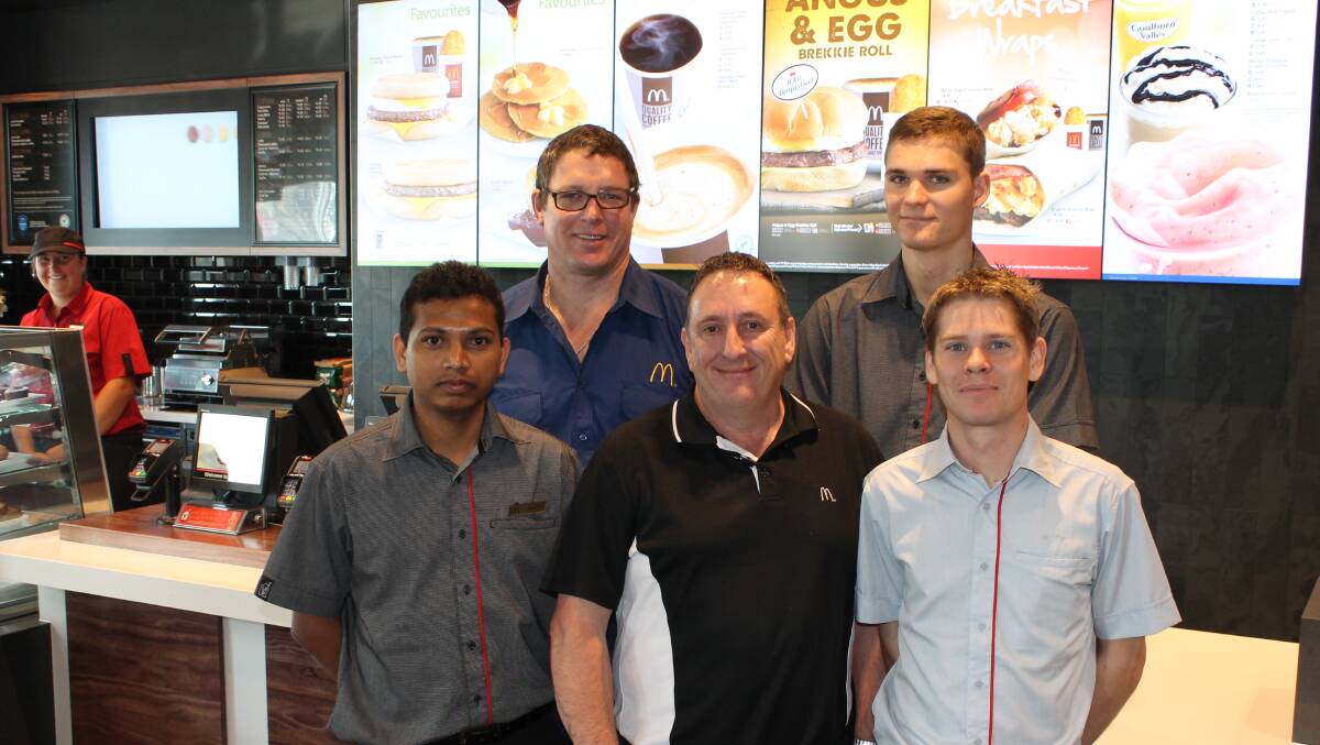 McDonald’s Bega store manager Russell Irish (front right) officially opens the fast food restaurant with (from left) store manager Kiran Mushke, maintenance Vincent Pook, franchisee Mike Goodluck and manager Louis Peters.