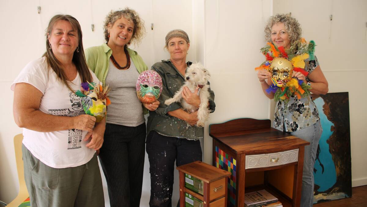 Among those helping to set up the International Women’s Day exhibition at Spiral Gallery yesterday are (from left) Robyn Williams, artist and training art therapist; Women’s Resource Centre coordinator Gabrielle Powell; woodwork artist Jo Saccomani (with four-legged friend Bowie) and WRC volunteer Rowena McConnell.
