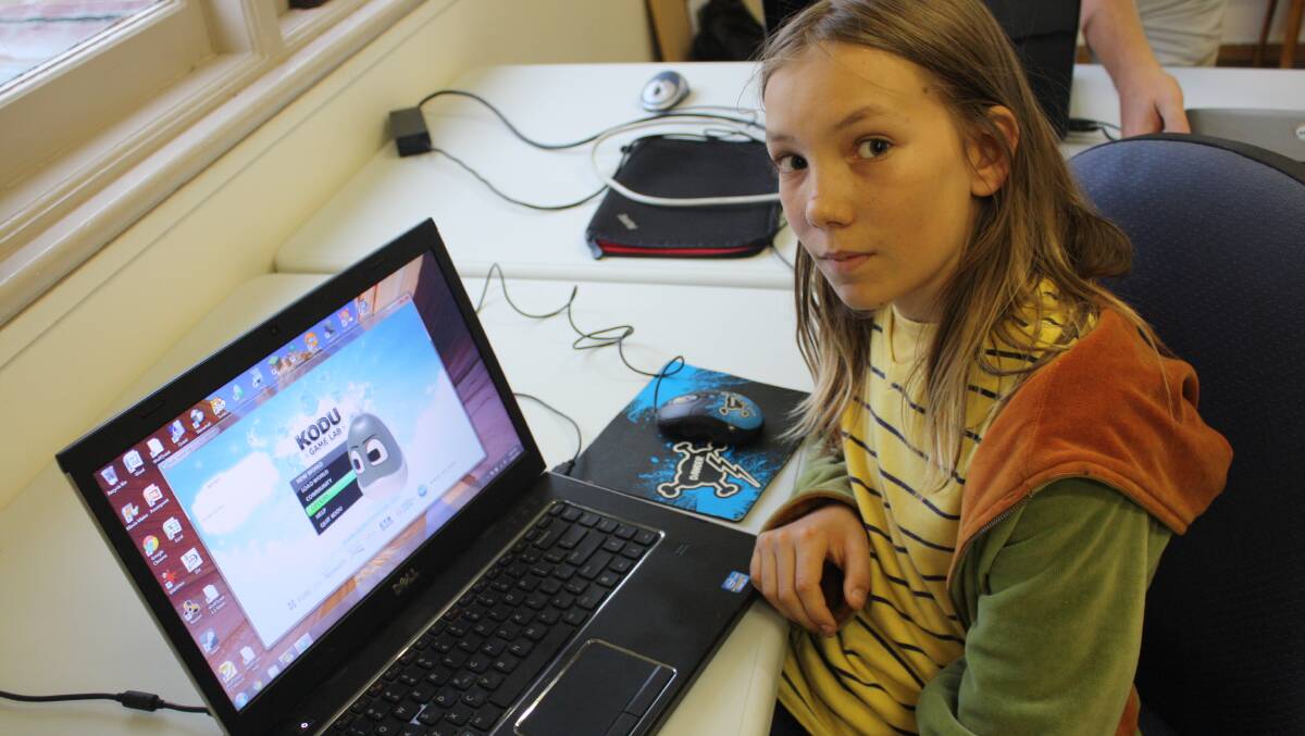 Aurin Yang, 12, demonstrates a simple 3D game creation software program called Kodu at a CoWS Near the Coast workshop on Friday night.