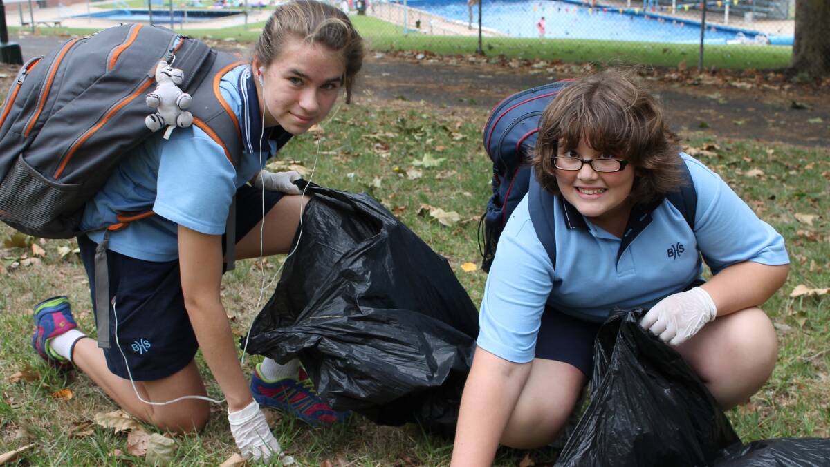 Grace Moore (left) and Anthea Charalambous help out during the Year 7 clean up effort.
