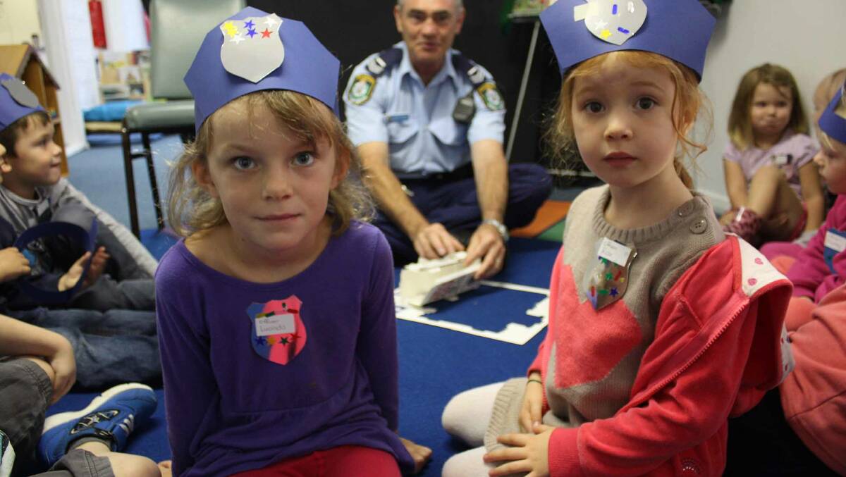 Lucinda Livingston and Rose Thompson enjoy the visit by local policeman Senior Constable Robert Dunlop.