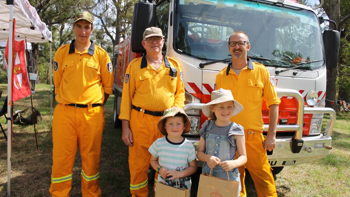 Working at the Bemboka Rural Fire Service stall are members (from left) Zac Franco-Mathewson, Graeme Damm and Kevin Ormes with (front) Joss and Maggie Ormes.