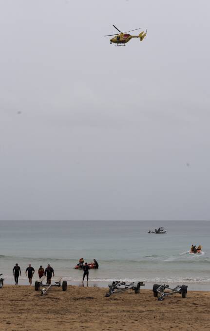 Emergency services continue the search for Christine Armstrong on Friday, who was taken by a shark while swimming at Tathra Beach. Photo: Graham Tidy, Canberra Times.