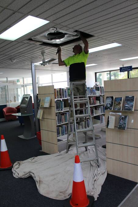 Workers install air-conditioning at the Bega library.