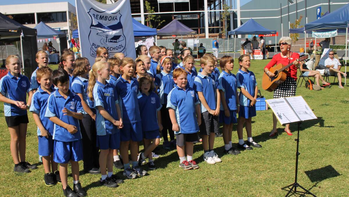 Bemboka Public School principal Jan Rogers leads the school choir in a performance at the SCPA Market in Bega.
