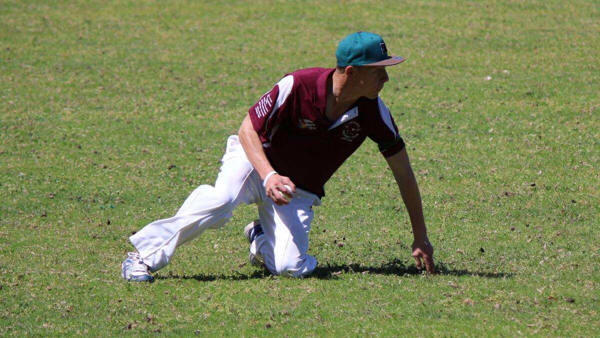 Tathra Sea Eagles Chris Dywer slides for a catch.