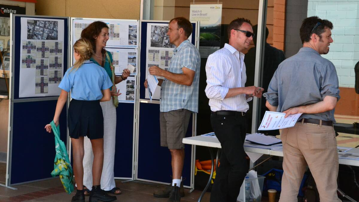 Representatives from the Bega Valley Shire Council and Spiire discuss landscape master plans with interested Bega locals last Friday.
