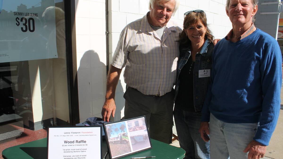 Selling tickets for the Lenno Footprint Foundation wood raffle are Brian Elliott, Jenny Wells and Ted Lowen.