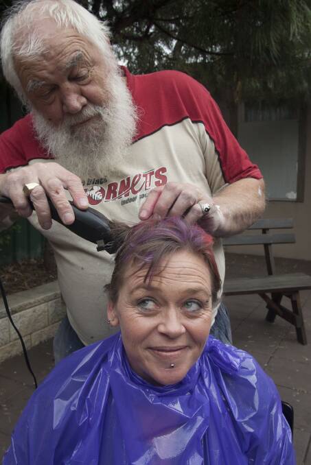 Wayne Walker has a go at clipping Dani-Maree Cuttle’s hair for Sunday’s charity fundraiser at the Grand Hotel in Bega.
