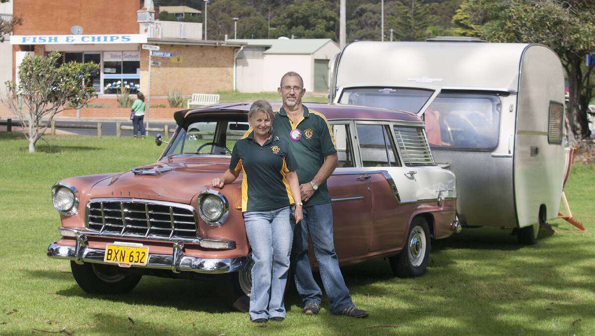Anthony Dack and his wife Kathy enjoy the sun next to their restored 1959 Holden SC Station Sedan and 1968 Tabbert Caravan.