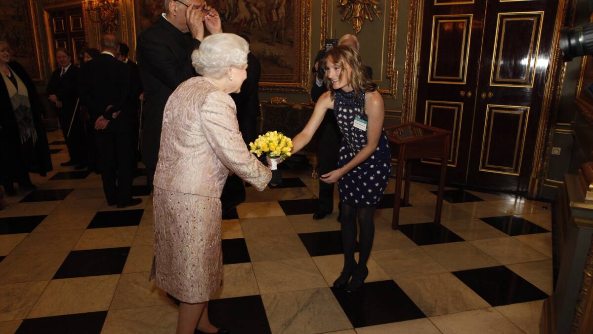 Ellie Seckold presents Her Majesty Queen Elizabeth II with a bouquet of flowers at a Commonwealth Day reception in London. Commonwealth Secretariat photo by Richard Lewis.