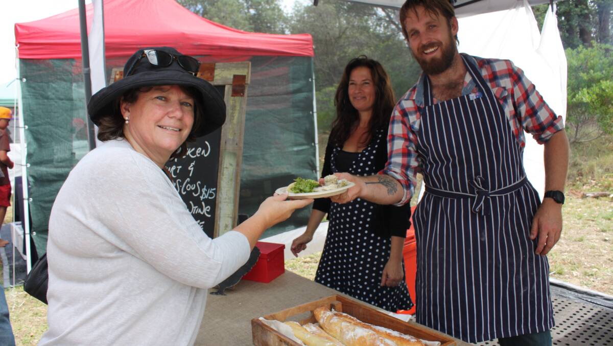 Linda Badewitz-Dodd tries out the offerings from Paul West's food stall.