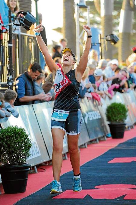 • An exhausted, but elated Katie Winkworth crosses the finish line of the Ironman Asia Pacific championship triathlon in Melbourne last weekend.