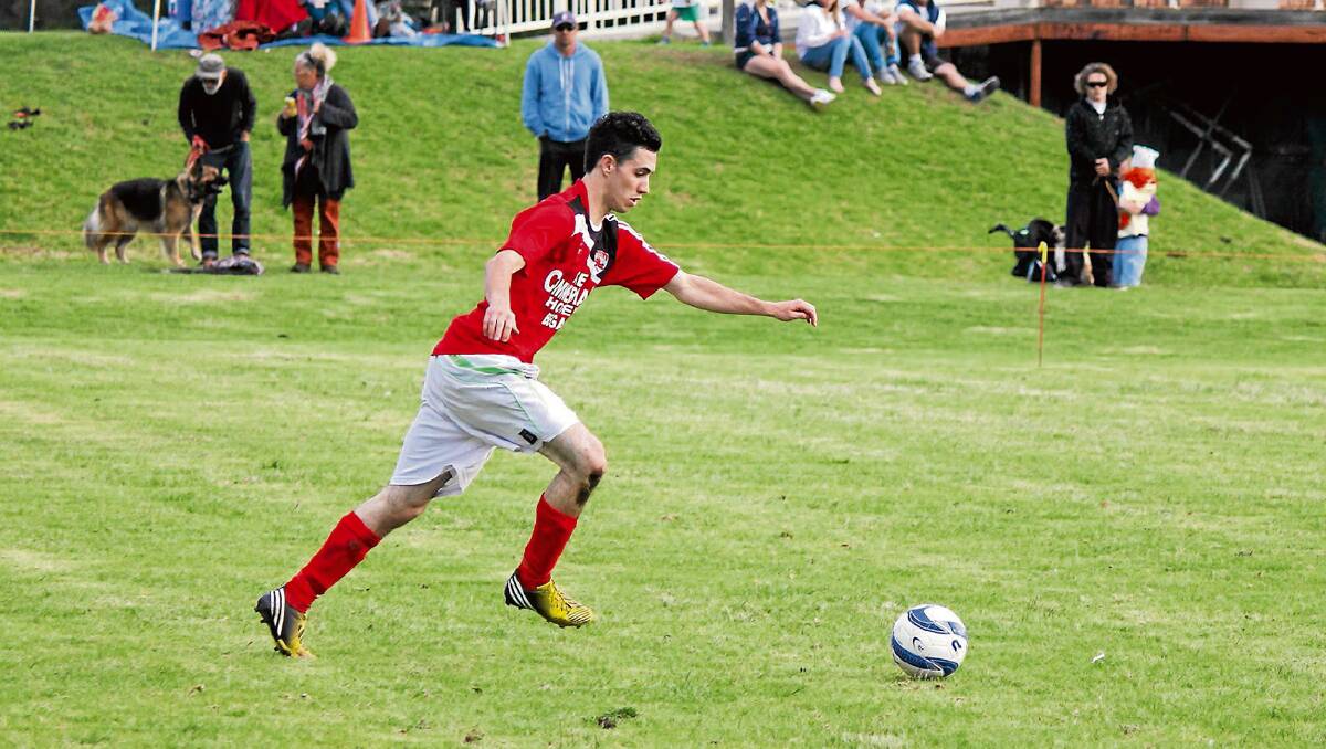 • Bega Devil Harley Cox lines up for a kick at goal during his double against the Merimbula Grasshoppers. 