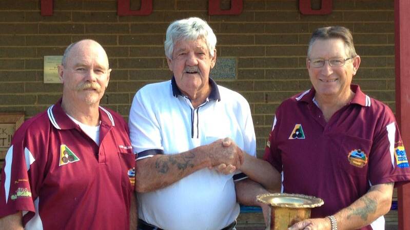 • Tathra bowling club’s singles championship runner-up Terry Wilson (left) and president Ray Coates congratulate Lynton Riddell on his win.