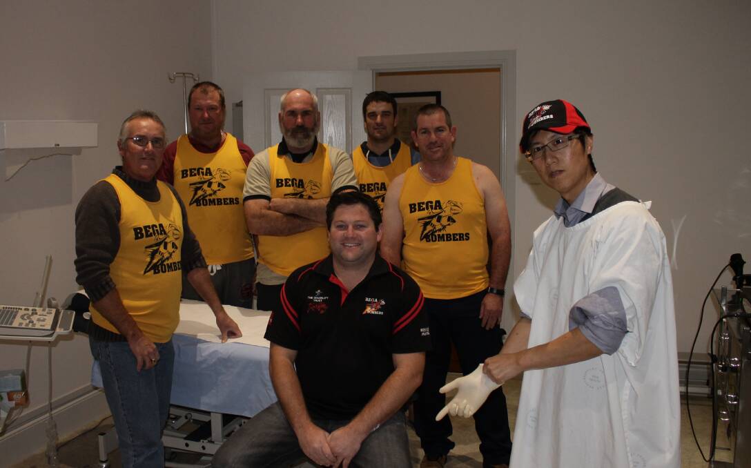 • Raising awareness of prostate cancer are Bega Bombers members (from left) Ronald Maloney, Andrew Lenon, John Cafe, Matt Fleet, Adam Blacka and Brad Brotherton, performing the checks is (right) Bega Urological Robotic surgeon Dr Chi Can Huynh.