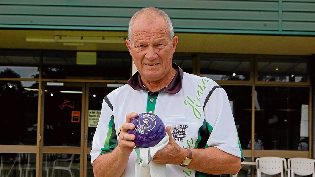 •  Frank Peniguel polishes a bowl as he prepares to play at the Eden Gardens Country club on Monday which was stop number 144 in his Guinness World Record attempt.