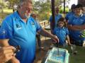 CAKE CUTTING: Jack Babidge having the honours of cutting the cake at the Club Narooma Bowlo Fishing Club birthday party.  