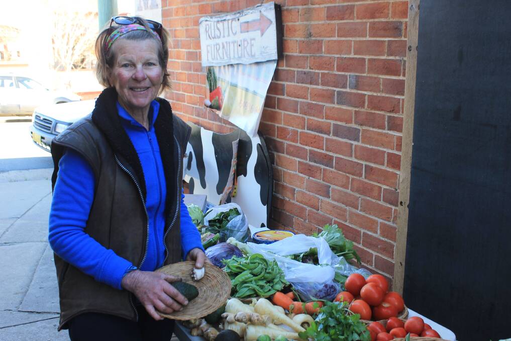 Janet Doolin next to her stall featuring produce from Cobargo Farm. 