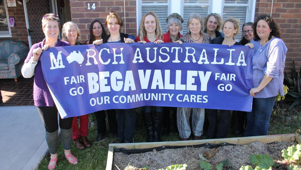 Outside the Bega Women’s Resource Centre supporters of the March in Bega Valley unfold a banner, including (from left) Elizabeth Blackmore, Bernie McKinnon, Carmen Goodall, Magella Blinkell, Anna Reilly, Anna Senior, Annie Franklin, Gabrielle Powell, Suzie Sequoia, Christine Quinton and Connie Eichler.