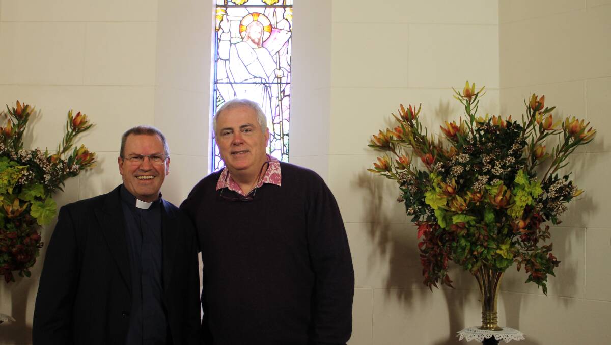 Ken Duncan (right) and Rev Ross Gear catch up at St John’s Anglican church after the presentation. 