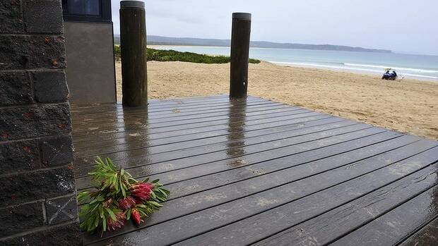 Flowers rest on the front verandah of the Tathra SLSC club rooms. PHOTO: Graham Tidy  
